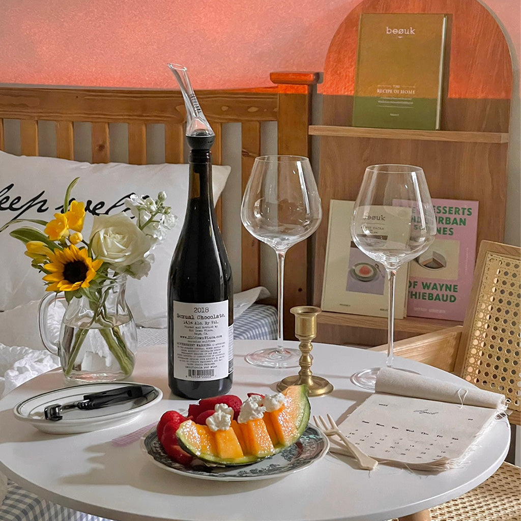Aesthetic wine night with sunflowers, melon, crystal wine glasses, and Vintorio aerator